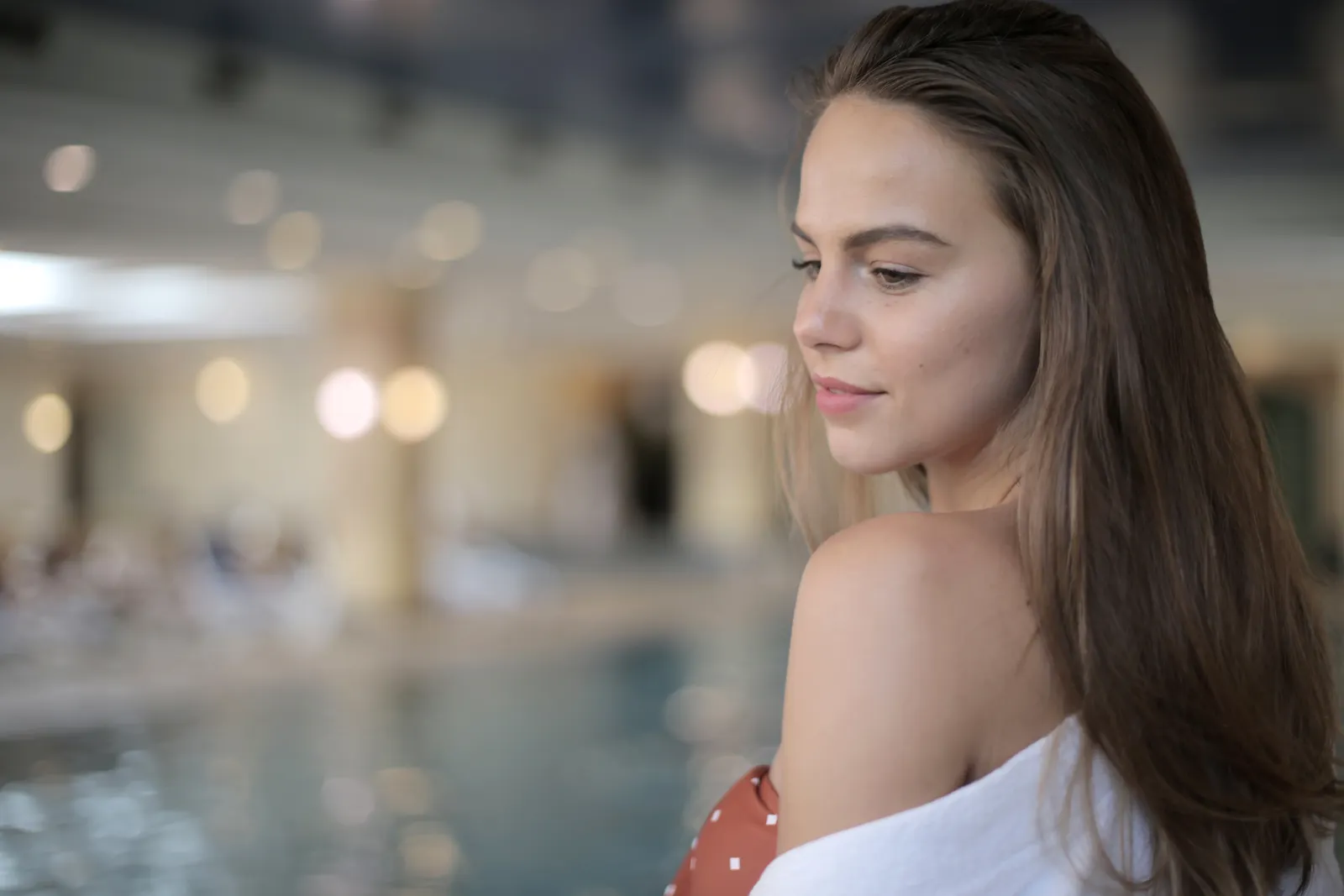 Woman relaxing in a softly lit spa interior