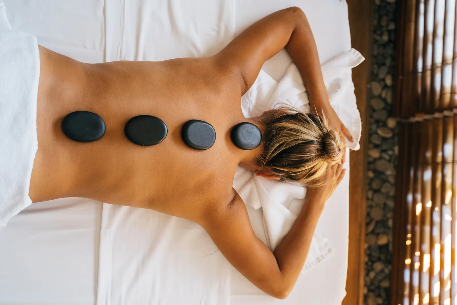 Hot stone massage session with heated stones in a spa setting